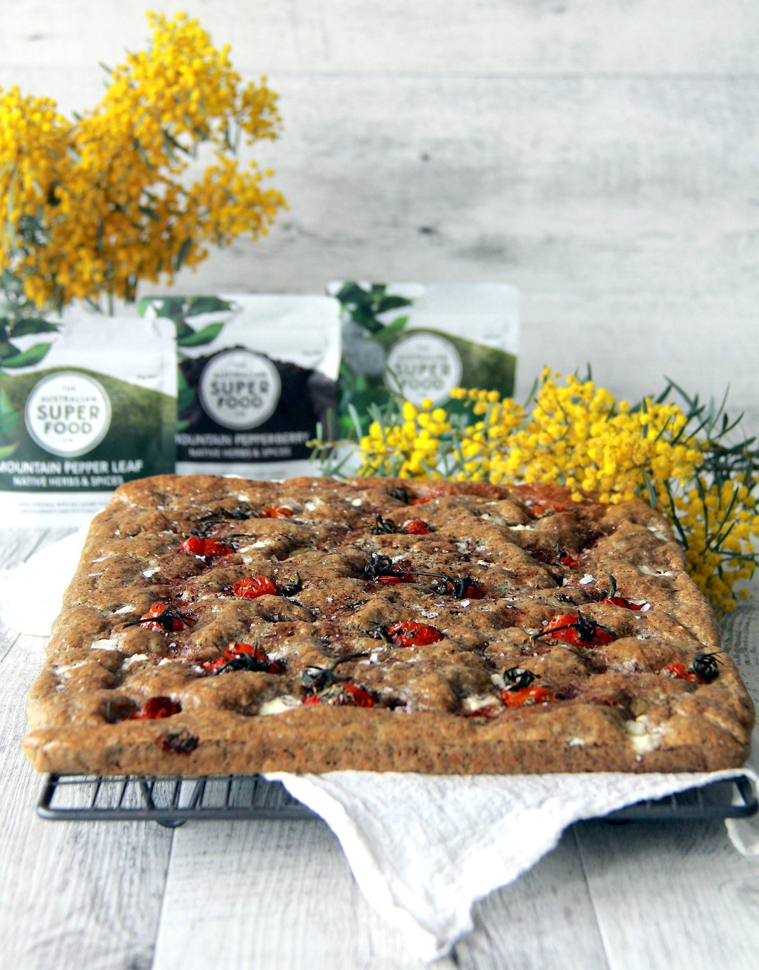 Mountain Pepper Leaf Focaccia with Pepperberry Roasted Tomatoes, Green Olives & Feta